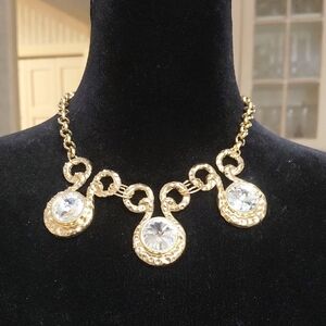 Gold tone metal Chain Necklace with Crystal Pendant Set. Has matching earrings..